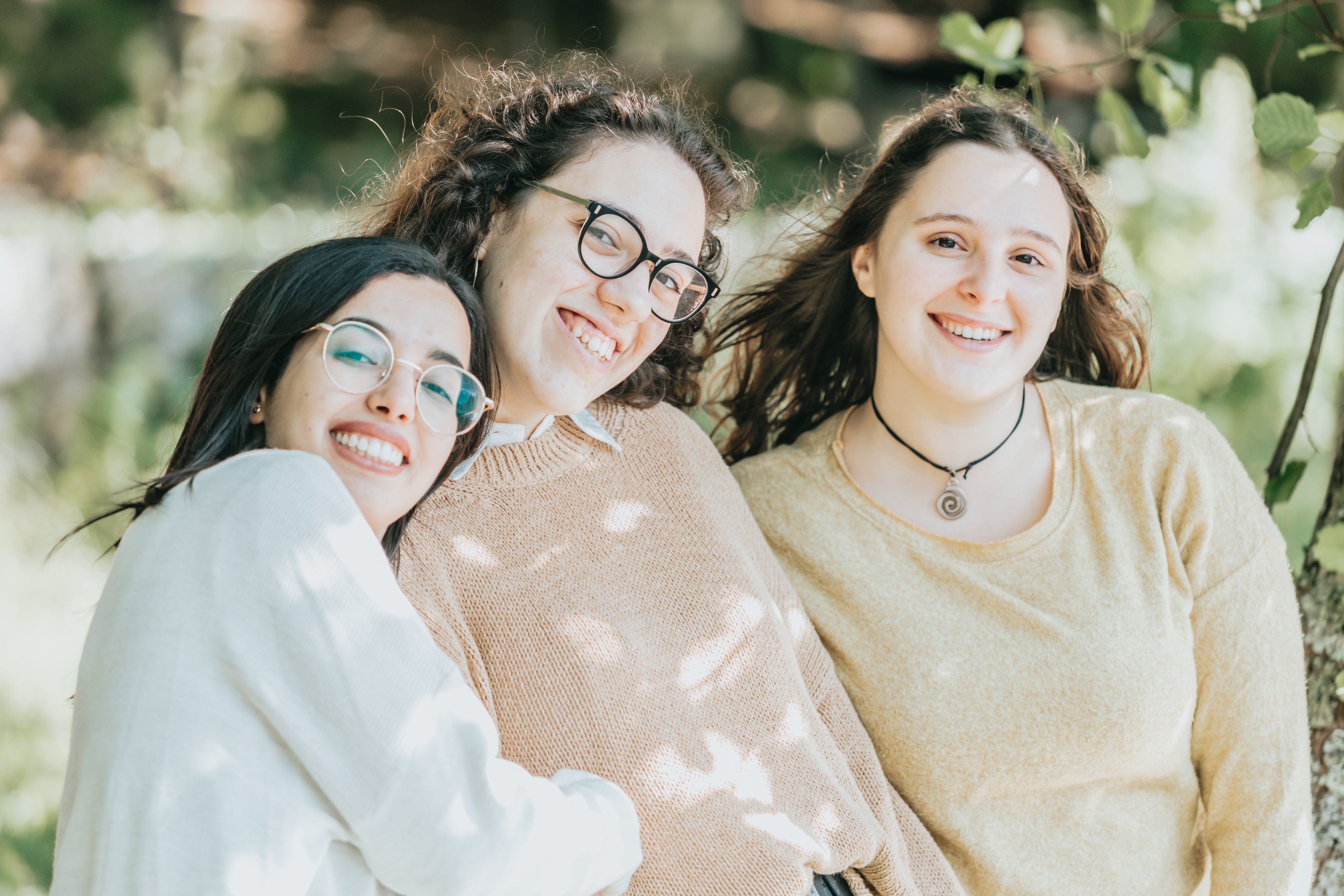 three-people-stand-in-shade-and-smile.jpg